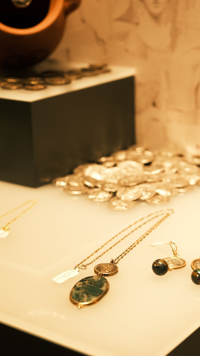 services-01 Showcase of elegant gemstone jewelry in a warm-toned display setting.