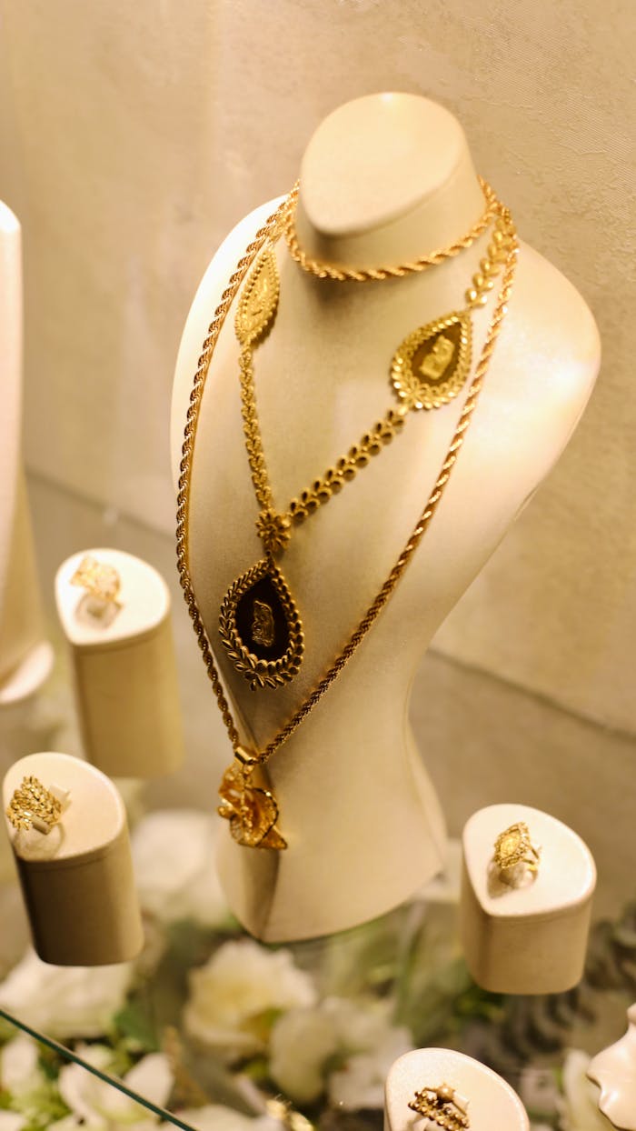 about-01 Luxurious gold necklaces and rings displayed elegantly in a jewelry shop in Idlib, Syria.
